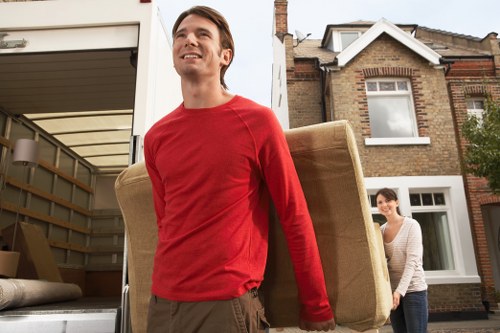 Careful loading of household boxes into a local moving van