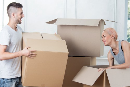 Professional movers handling commercial items and packed boxes