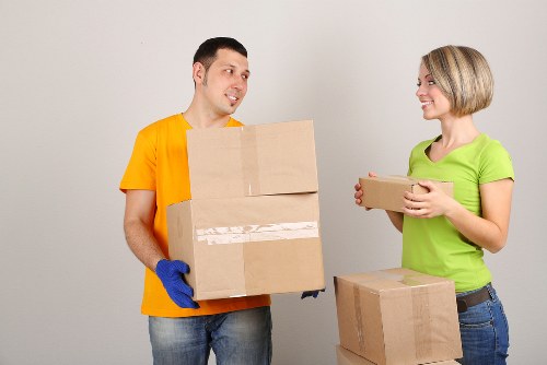 Removalists loading boxes and household items for a Catford move